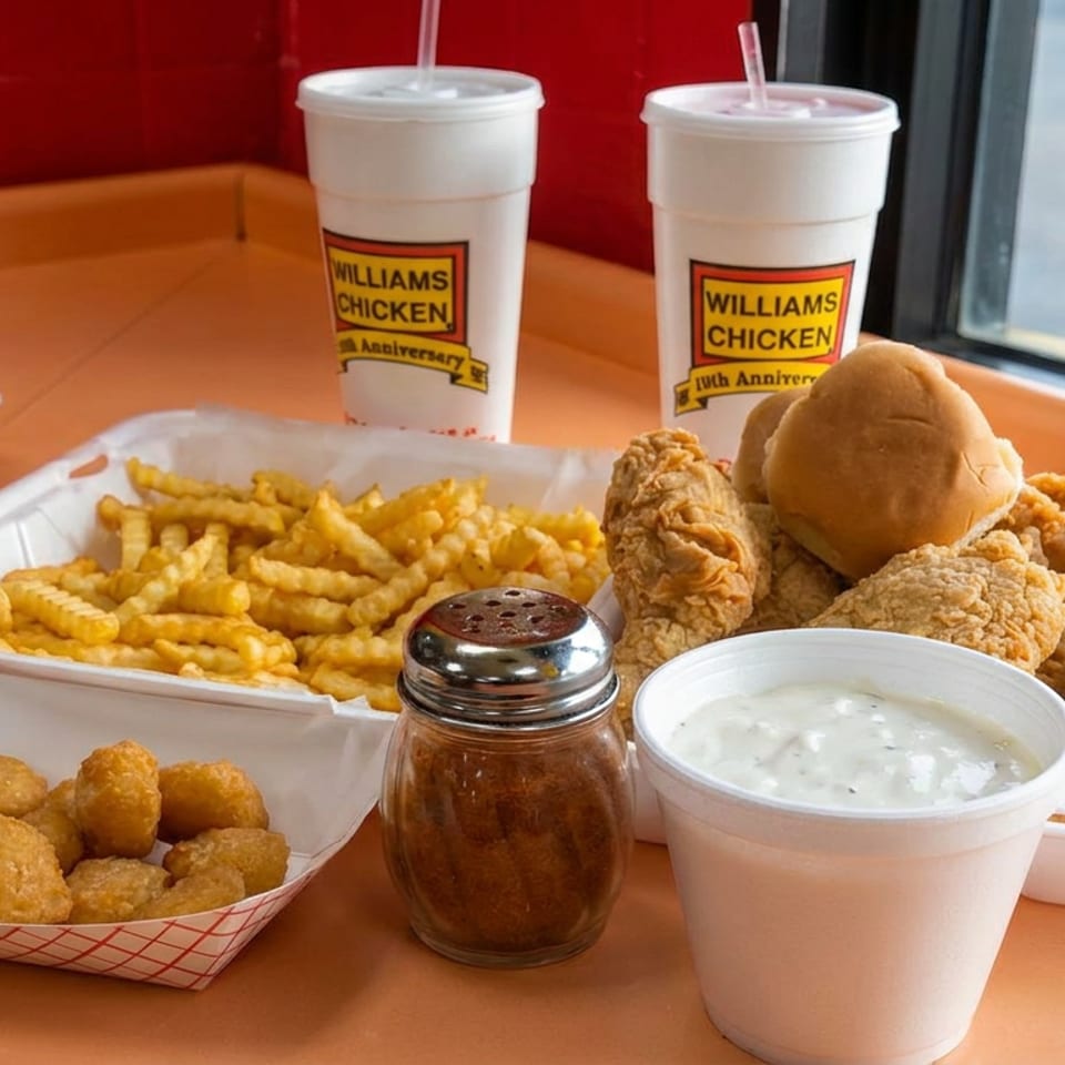 Williams Chicken meal featuring fried chicken, crinkle-cut fries, hush puppies, coleslaw, seasoning, and two fountain drinks.
